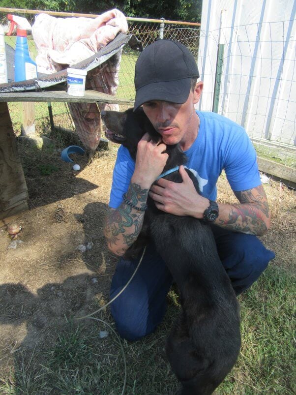 Lab mix Rusty getting a hug from a PETA fieldworker