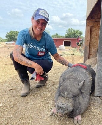 Photo of Tara and a grey pig